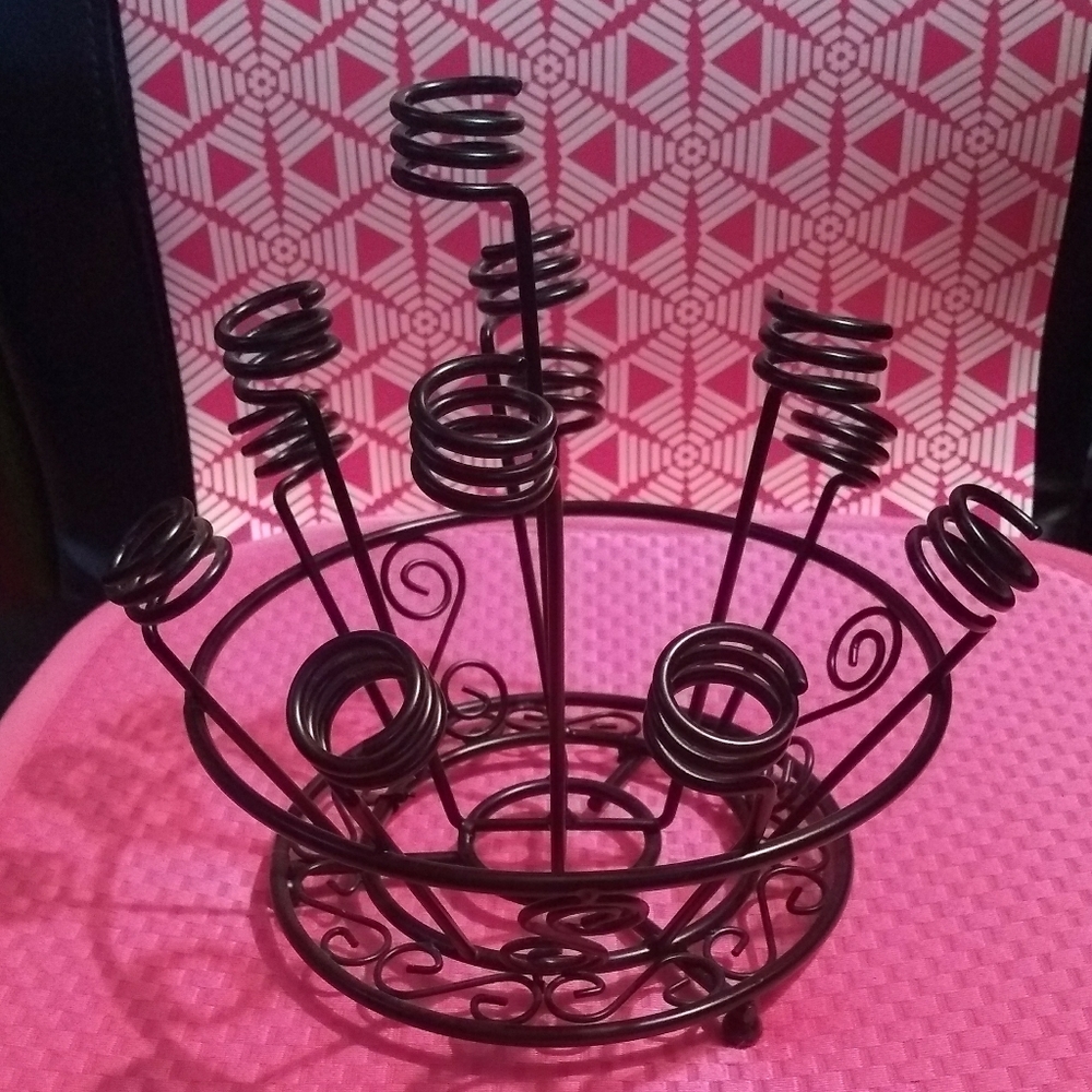 Sturdy black metal bottle stopper display, very attractive on a bar cart.